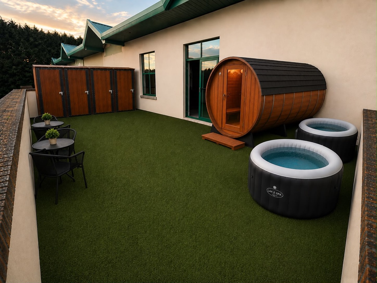 Outdoor terrace with a cedar barrel sauna and two chilled plunge pools